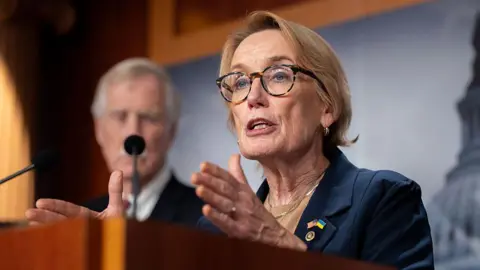 Getty Images Senator Maggie Hassan speaks at a press conference 