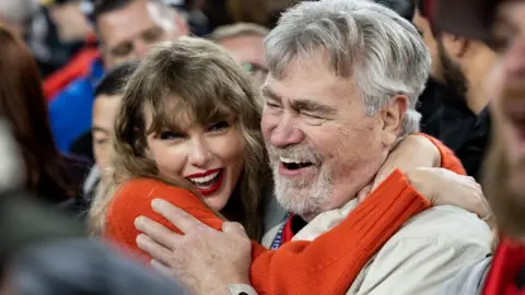 Getty Images Taylor Swift hugs Ed Kielce after the AFC Championship NFL football game between the Kansas City Chiefs and the Baltimore Ravens at M&T Bank Stadium on January 28, 2024 in Baltimore, Maryland