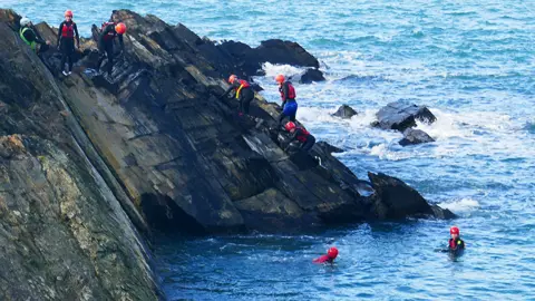 Getty Images People coasteering near Pembrokeshire's Blue Lagoon