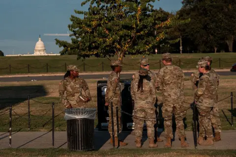 National Guard troops appear in Washington DC as mayor rejects 'authoritarian push' Getty Images Troops seen standing with the US Capitol building in the background