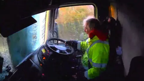A screengrab of Christopher Tribe in the lorry after it has just crashed.