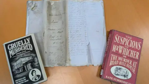 Hannah Lyddy A piece of old parchment with old-style handwriting and two books beside it.