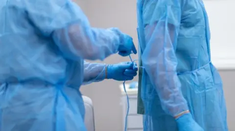 Getty Images Two surgeons preparing for surgery