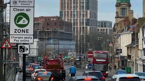 Rush hour traffic with buses, cars and bikes travelling through Old Market.