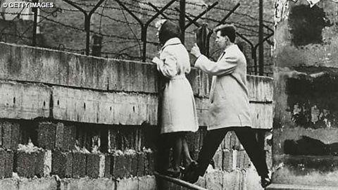 People looking over the Berlin Wall