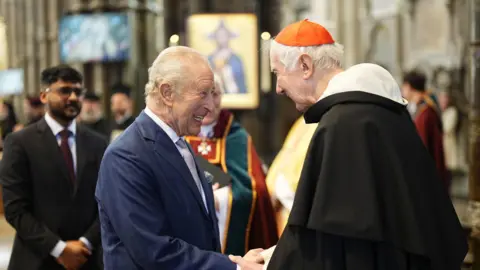 PA Media King Charles spoke to Cardinal Timothy Radcliffe at Westminster Abbey