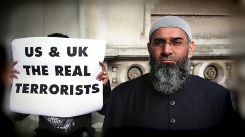 Anjem Choudary and a poster calling the UK "real terrorists"