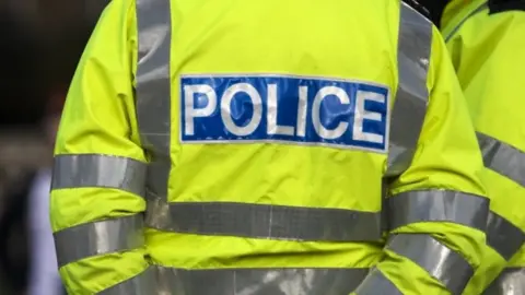 Getty Images Generic image of a person wearing a police high-vis jacket