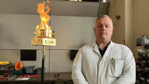 BBC An engineer next to a beacon