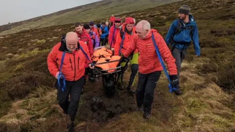 Mountain rescuers evacuating the casualty