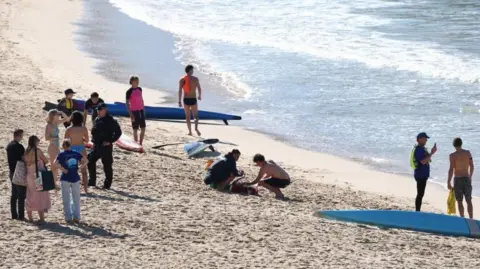 Police officers speak to people following a shark attack at Coogee Beach in Sydney, Australia. Photo: 13 June 2026