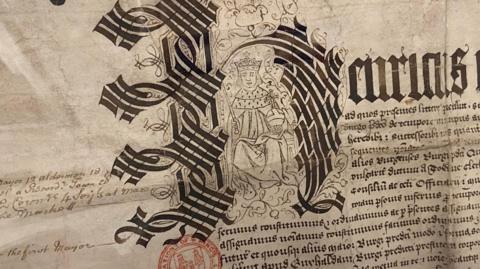 Old document showing ornate letter H with a line drawing of Henry VIII inside the letter