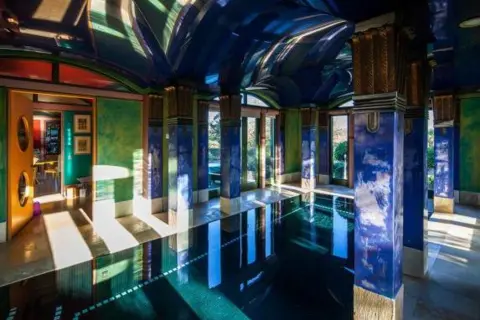 Phil Sayer / C20 Society The swimming pool wing of Sphinx Hill, with rich blue and gold columns and mosaic flooring