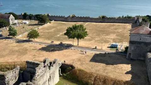 English Heritage Large parch marks can be seen from Portchester Castle tower on a lawn within the castle's walls.