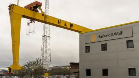 Getty Images A Harland & Wolff crane beside a grey office building with the company's logo