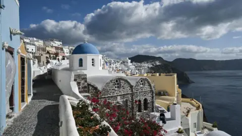 Getty Images This photograph shows a general view of the Oia village on the Greek island of Santorini while the authorities restrict the access to the tourists in some areas as a precaution due to recent seismic activity on February 5, 2025