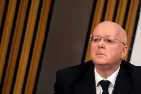 Reuters Peter Murrell sitting in parliament while being questioned by MSPs