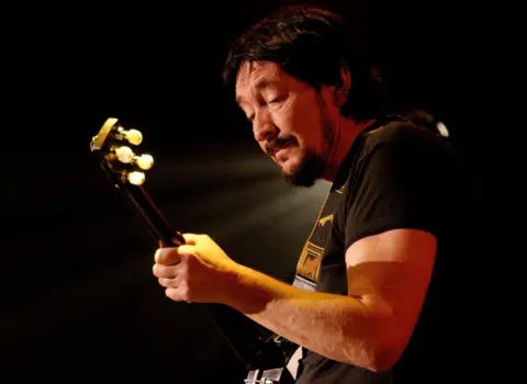 Getty Images Chris Rea playing his guitar