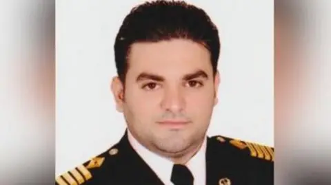 Abdul Samin Man wearing a naval uniform looking directly at the camera