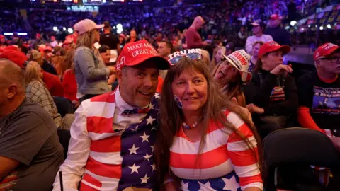 A antheral   and a pistillate   dressed successful  USA emblem  colours astatine  the Madison Square Gardens Trump rally 