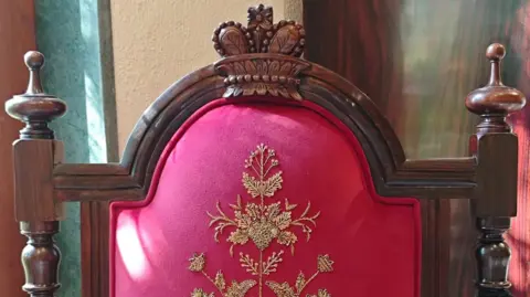Cherylann Mollan The chair features a wooden crown motif and Zardozi work - a style of metal embroidery that flourished in India during the Mughal era
