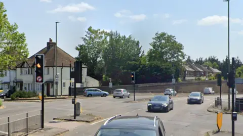 A Google Map image of a road junction with cars.