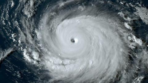 Satellite image of hurricane Frankin showing the eye of the storm surrounded by a huge swirl of cloud in a circluar shape