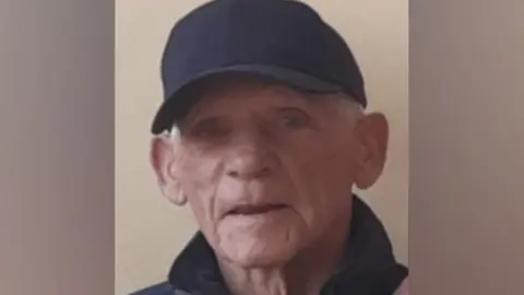 North Yorkshire Police An older man with grey hair, wearing a black baseball cap and jacket.