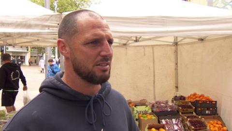 Tommy Coyle standing at his family fruit and veg stall following a fire