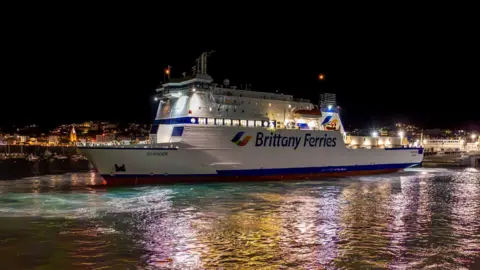 Brittany Ferries on the sea in night time at St Peter Port, Guernsey