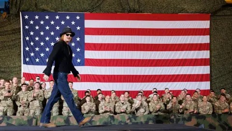 Musician Kid Rock introduces U.S. Vice President JD Vance to speak in front of members of the US Military on November 26, 2025 in Fort Campbell, Kentucky. 