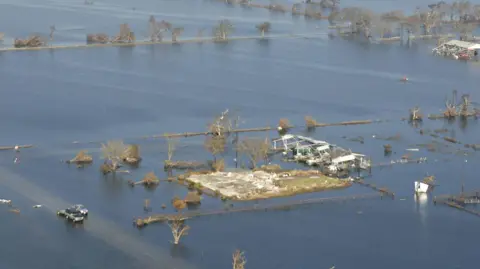 AFP via Getty Images A flooded landscape in Cameron Parish after Hurricane Rita