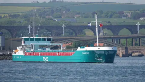 Port of Berwick A cargo ship is on the port of Tweed it is called the Tharsis 