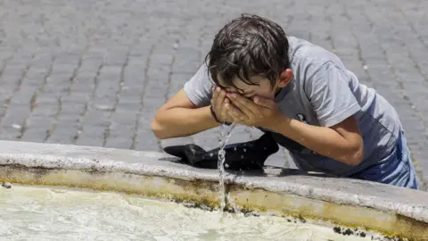 Getty Images Boy drinking water during heatwave