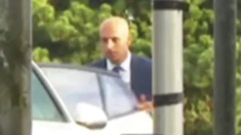 Dr Raed Al-Mobayed getting into his car