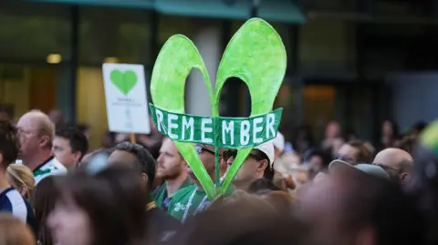 People take part in a silent march in west London in memory of those killed in Grenfell Tower.
