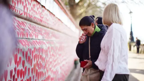 PA Media People at the National Covid Memorial Wall in London before a ceremony marking the fifth anniversary of the Covid-19 pandemic. Picture date: Sunday March 9, 2025.