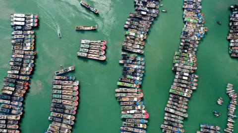 Reuters A drone view shows fishing boats being moored as Typhoon Gaemi approaches, in Lianjiang county of Fuzhou, Fujian province