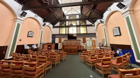 John Nurden Inside a church there are seats facing the front