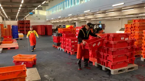 Workers at the Plymouth fish market