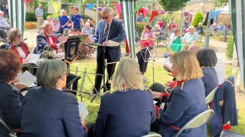 A brass band playing for care home residents