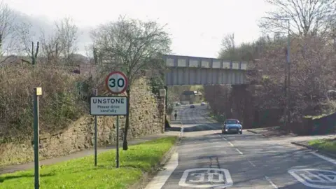 Google A Google street view of the main road into Unstone with a rail bridge over the road