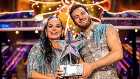 Scarlett Moffatt and Vito Coppola with this year's Strictly Come Dancing Christmas trophy 