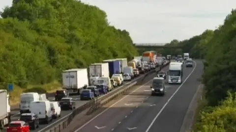 Queues of traffic on a busy motorway.