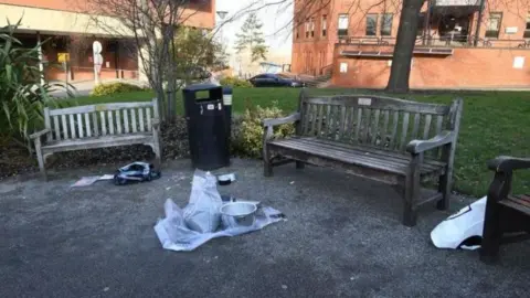 Counter Terrorism Policing North East A device lies on the ground outside the hospital between two wooden benches and a waste bin.