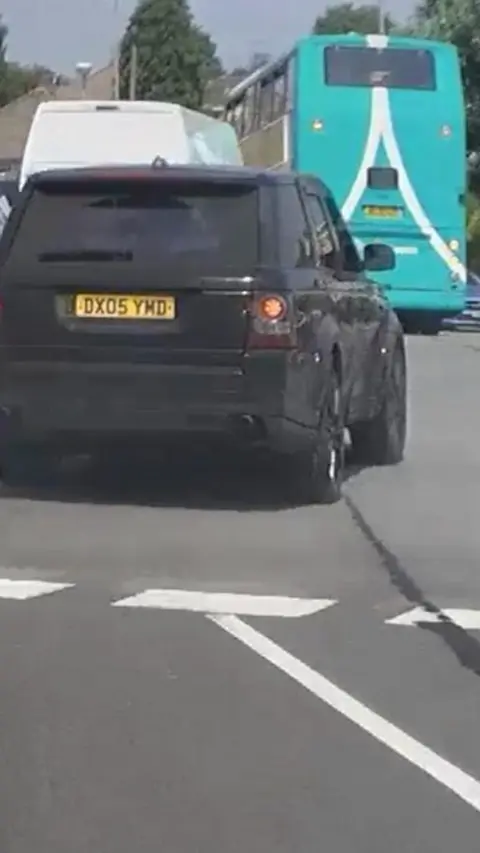Dashcam screenshot of a black Range Rover