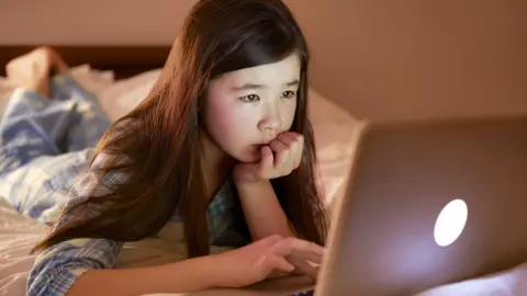 Get a young girl using a computer