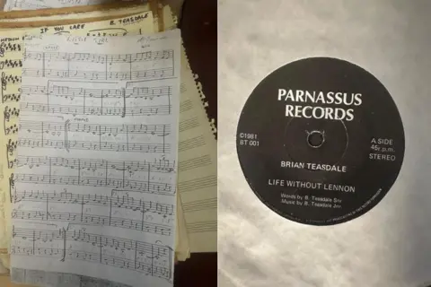 Karen Teasdale-Robson An image of the hand-written paper score for the lullaby Brian Teasdale wrote for his daughter alongside another image of a vinyl copy of Life Without Lennon which Brian Teasdale also wrote and published.