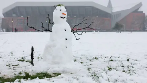 PA Media A snowman is visible outside Anfield stadium in Liverpool ahead of the Premier League showdown against Manchester United.