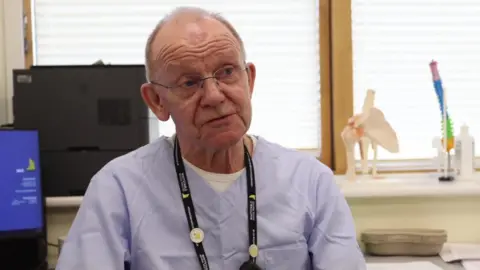 BBC/Michael Keohan Dr John Ribchester in his treatment room at the Whitstable medical practice.
